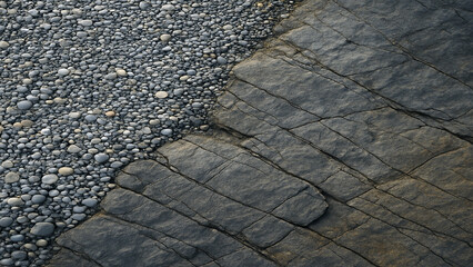Close up of gray pebbles and cracked dark gray rock