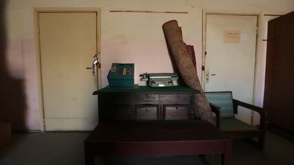 A montage featuring a large vintage wall clock sitting among clutter, followed by a pile of colorful, dusty rotary and push-button telephones in a storage space.