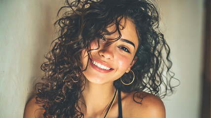 hispanic young woman smiling at the camera with soft natural lighting warm tones and a genuine expression creating a modern portrait full of charm and positivity