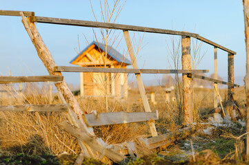Beautiful rural landscape bathed in warm golden light during sunset, with fields, trees, and open countryside creating a serene and peaceful atmosphere. Soft light highlights textures and colors 