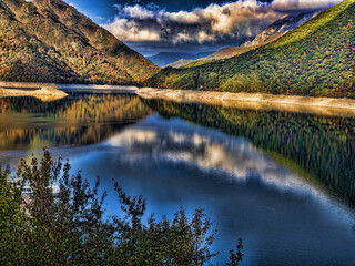 Clouds are reflected on the surface of the Piva dam lake. Montenegro