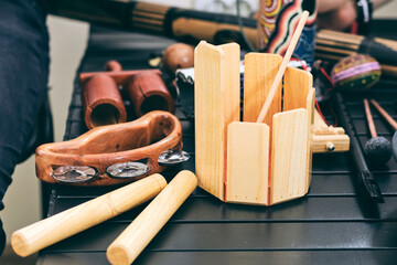 Assortment of wooden percussion instruments arranged on a table in a music setting