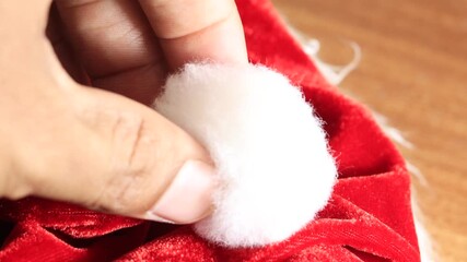 Hands grabbing santa claus hat - Powered by Adobe