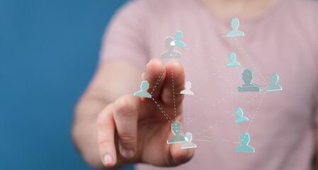 Person's hand touching a network of connected people, symbolizing social media, online connections, and digital networking. Illustrative of team