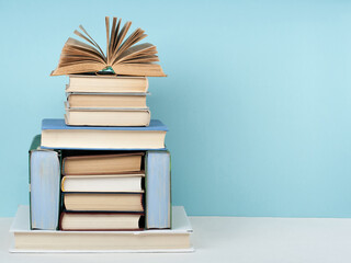 Open book, hardback colorful books on wooden table. Back to school. Copy space for text. Education business concept.