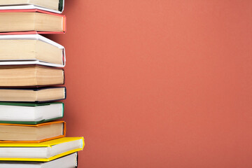 Open stacking book, hardback colorful books on wooden table. Back to school. Copy space for text. Education business concept.