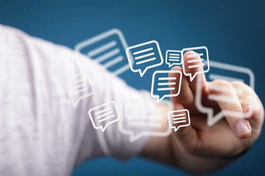 Person interacting with digital speech bubble icons, concept of communication, connection, and social media.