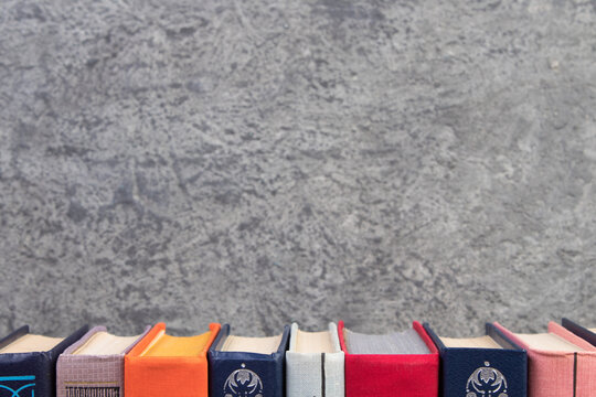 open book, books on the gray concrete background. Back to school. Education. Copy space for text.