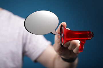 Image of a person holding a red megaphone with a speech bubble, perfect for communication, announcements, and concepts like message and informat