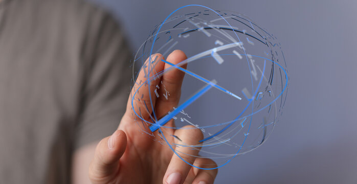 Abstract conceptual image of a hand holding a glowing digital sphere, symbolizing technology, global connection and data visualization