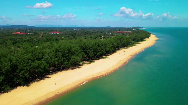 Aerial view of Pantai Bukit Keluang, Besut, Terengganu, showing turquoise waters, coastal cliffs, and clear sunny skies along the scenic shoreline.