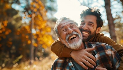 A joyful father and adult son share a warm hug outdoors in autumn light. Their genuine smiles create an uplifting, emotional moment. Useful for family, happiness, lifestyle, and generational themes.