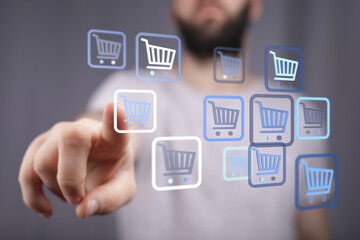 Person interacting with shopping cart icons representing online store purchases and e-commerce transactions. Digital shopping experience and con