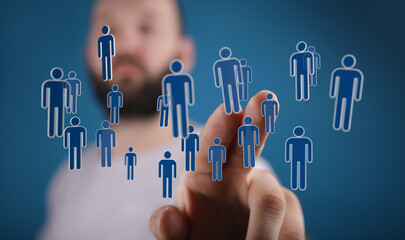 Man's hand interacting with virtual human icons, representing social networking, teamwork, and global connectio