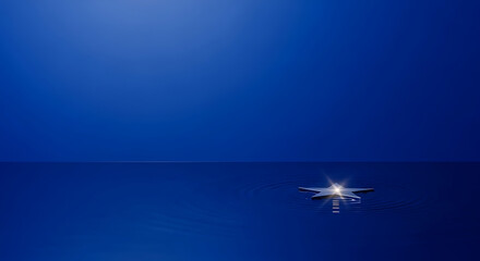 Shiny metallic star floating on deep blue water, creating gentle ripples. A minimalist, symbolic image representing hope, dreams, or guidance. Ideal for inspirational or conceptual designs.