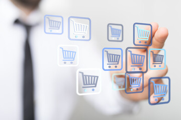 A close-up of a hand selecting digital shopping cart icons, representing online shopping, e-commerce, and digital transactions.