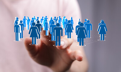 Hand touching digital human icons representing a connected global team, representing concepts like teamwork and digital networking.