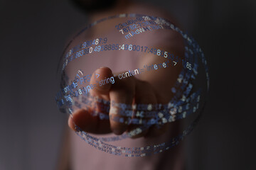 A hand interacts with a digital sphere, symbolizing technology, innovation, and data processing. Concept of internet, coding, and the