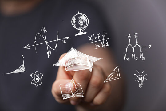 Conceptual image of digital education, science, and innovation. A hand touches a virtual screen displaying academic icons, formulas, and symbols