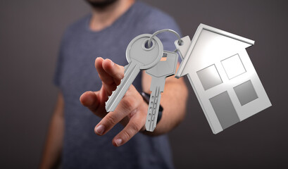 Person offering keys with house shaped keychain. Buying a house, concept of home ownership and real...