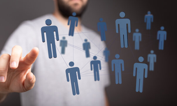 Concept of social network and communication. Human hand pointing to a network of digital figures representing people. - Powered by Adobe