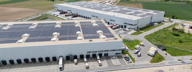 Logistics centers with solar panels on roofs. Aerial view