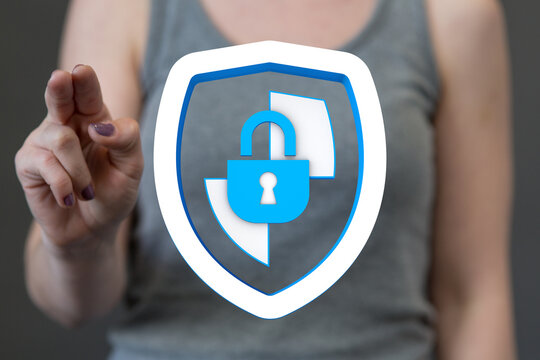 Woman interacting with a digital shield icon symbolizing online protection and data security, padlock to represent safety.