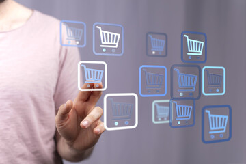 A person's finger touching a digital shopping cart icon, representing online shopping, e-commerce, and digital transactions. Concept of easy sho