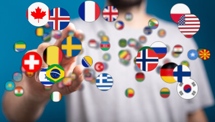 Conceptual image of a hand touching global flags representing international relations,...