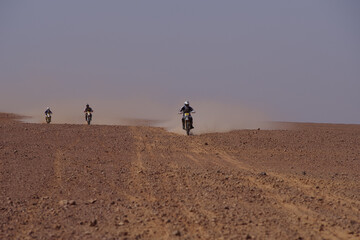 Motorcycle Rally Crossing the Algerian Desert Kicking Up Dust