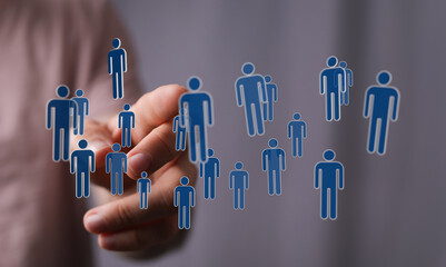 Hand reaching out to connected people icons, representing social networking, global communication and business.