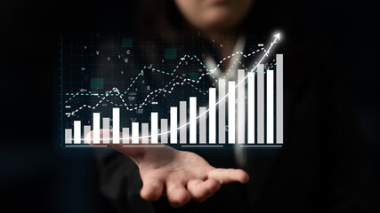 A business professional showcases digital graphs and charts representing financial growth and trends, illustrating data analytics in a modern corporate environment. Impute
