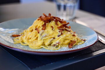 Fresh pasta    tonnarelli alla carbonara and Aperol Spritz  at  typical italian resaturant at Trastevere   neighbourhood at Rome 