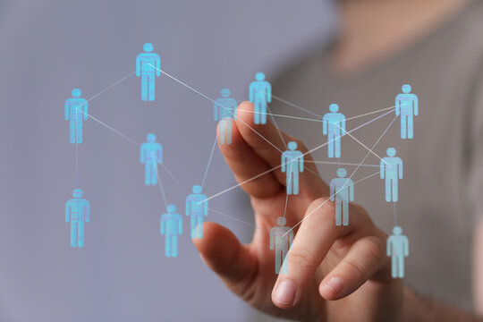 Hand touching digital network human icons, representing social connections, technology, communication, and team - Powered by Adobe