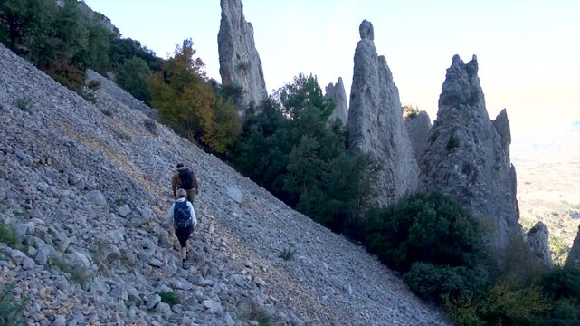 Slow motion, a copule walking on a rocky path in Serrella mountain, Alicante (Spain).