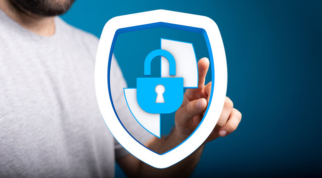 Concept of cybersecurity and data protection. Hand interacts with a digital shield and padlock, symbolizing internet safety, privacy