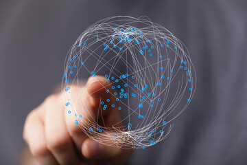 A hand touches a 3D globe made of lines and dots, symbolizing global connection, internet, and communication. Represents network, tec