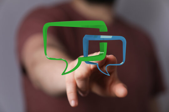 Abstract image of a hand touching a green and blue speech bubble, representing communication and connectivity.