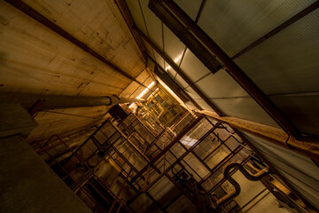 Abandoned Industrial Interior - Rusty Pipes, Metal Catwalk and Moody Golden Light