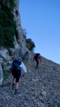 Slow motion, a copule walking on a rocky path in Serrella mountain, Alicante (Spain).