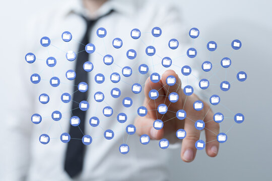 A businessman touching a digital data network of connected folders representing cloud computing and information - Powered by Adobe