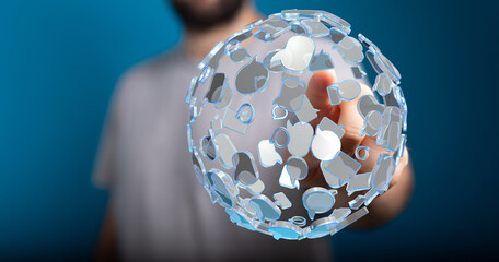 A person's hand reaches towards a glowing sphere made of speech bubbles, representing communication, social interaction, and digital connection.