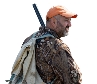 A hunter with a gun in camouflage clothing. A senior man with a gun, medium shot, searching for game.