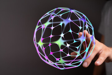 Close-up of a hand touching a luminous 3D sphere representing technology, connections, and global networks. Concept for communication