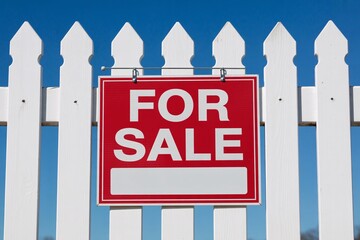 Real estate for sale sign on white picket fence home property investment