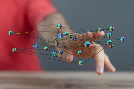 Close-up of a hand reaching for a network of connected geometric shapes representing technology and connections