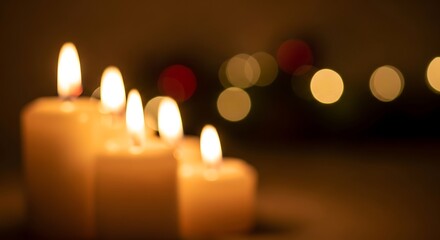 Soft glow of burning candles with bokeh lights in the background