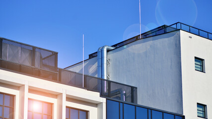 Office building in loft style. Facade of commercial office with windows. White walls of an industrial building.