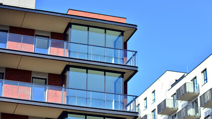 Obraz premium Modern luxury residential flat. Modern apartment building on a sunny day. Apartment building with a blue sky. Facade of a modern apartment building.