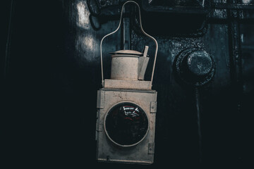 Vintage Railway Lantern Against Industrial Metal © JAGDrone